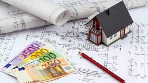 an architect's blueprint with euro money. symbolic photo for funding and planning of a new home.